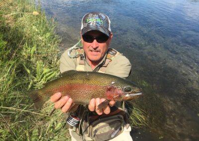 Green River Fishing Guide at Dutch John Resort Is Releasing Huge Beautiful Variegated Striped Rainbow Trout Into The Green River