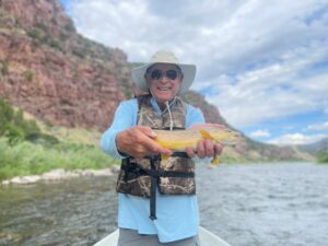 Trophy size Brown trout ready for release back to his home in the crystal clear Tail Waters Of The Green River By Dutch John Resort At Flaming Gorge 