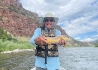 Trophy size Brown trout ready for release back to his home in the crystal clear Tail Waters Of The Green River By Dutch John Resort At Flaming Gorge