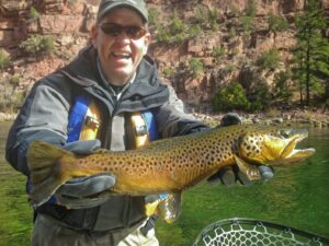 Green river fly fishing guides with trophy wild brown trout ready to br safely released back into the green river.