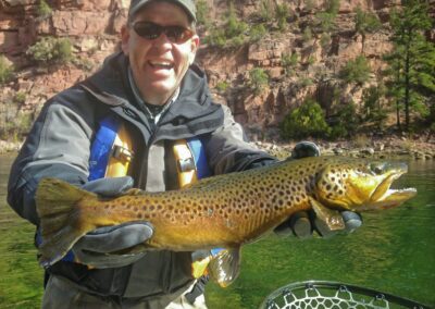 Green river fly fishing guides with trophy wild brown trout ready to br safely released back into the green river.