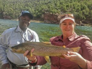 Green river fly fishing guides with trophy wild brown trout ready to br safely released back into the green river.