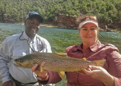 Green river fly fishing guides with trophy wild brown trout ready to br safely released back into the green river.