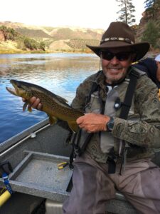 Green river fly fishing guides with trophy wild brown trout ready to br safely released back into the green river.