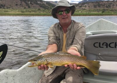 Drift Boat Fly fishing guest of Dutch John Resort Fishing Guides releasing large green river wild trout into the tail waters below Flaming Gorge Dam into the Green River
