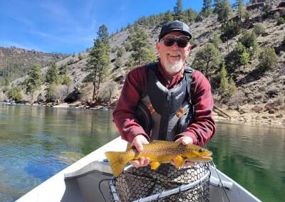 Drift Boat Fly fishing guest of Dutch John Resort Fishing Guides releasing large green river wild trout into the tail waters below Flaming Gorge Dam into the Green River